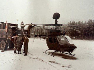 Steve with soldiers by a helicopter